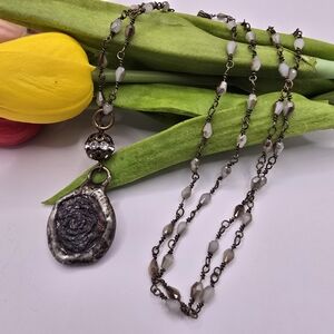 Elegant Beaded Necklace with Silver Stamp Pendant